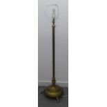 A BRASS STANDARD LAMP, THE COLUMN ADJUSTABLE FOR HEIGHT ON HEAVY CIRCULAR BASE, RAISED ON FEET AND
