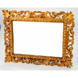 PIERCED GILT GESSO WALL MIRROR, the oblong plate in a moulded frame with pierced rocaille scrollwork