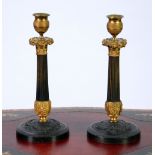 PAIR OF REGENCY PERIOD DARK PATINATED AND GILT BRONZE CANDLESTICKS, with gilt pedestal case shape