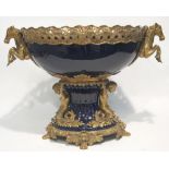 A TWENTIETH CENTURY BLUE GLAZED CERAMIC AND CAST BRASS MOUNTED TABLE CENTREPIECE, the oval galleried