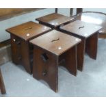 SET OF FOUR OAK ECCLESIASTICAL STOOLS WITH PANEL SEATS AND PANEL SUPPORTS WITH PEGGED STRETCHER