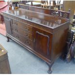 A FIGURED MAHOGANY SIDEBOARD, IN CHIPPENDALE STYLE WITH TRELLIS PIERCED LEDGE BACK, GADROON