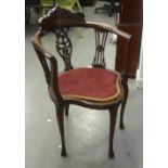 AN EDWARDIAN ROCOCO CARVED WALNUTWOOD CORNER ARMCHAIR