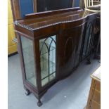 A MAHOGANY DWARF DISPLAY CABINET WITH LEDGE BACK; GADROON BORDERS, THE BOW FRONTED CENTRE CUPBOARD