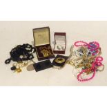 A QUANTITY OF COSTUME JEWELLERY TO INCLUDE; A SILVER LOCKET AND CHAIN, EARRINGS, NECKLACES, BEADS