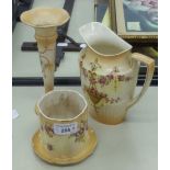 THREE IVORY GROUND FLORAL PRINTED VASES, A JUG AND A JAR WITH SAUCER SHAPED BASE