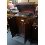 A MAHGOANY CASED VINTAGE RADIOGRAM WITH LIFT-UP TOP AND TWO DOOR FRONT, 24" WIDE, 3'8" HIGH (A.F.)