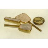 A GILT METAL LADY'S DRESSING TABLE THREE PIECE BRUSH AND MIRROR SET AND A SIMILAR TRINKET BOX