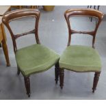 A PAIR OF MAHOGANY DINING CHAIRS, WITH OPEN WAISTED BACK AND GREEN OVERSTUFFED SEATS