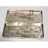 A CHROMIUM CASED SET OF SILVER AND WHITE METAL PIG CASTRATION IMPLEMENTS SOME MARKED 'THACKRAY'