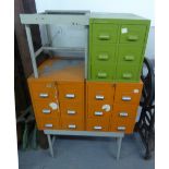 A GREY METAL NEST OF SIX CARD INDEX DRAWERS ON STAND AND TWO RED METAL NESTS EACH OF SIX FILING