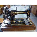 A WOODEN CASED SINGER SEWING MACHINE WITH INSTRUCTION MANUAL
