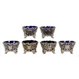 SET OF SIX EARLY VICTORIAN ROCOCO SILVER CIRCULAR SALTS with blue glass loose, shell embossed,