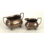 LATE VICTORIAN SILVER SUGAR AND CREAM SET, of part fluted, rounded oblong form with angular scroll