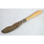 A VICTORIAN SILVER BUTTER KNIFE with shaped and foliate scroll engraved blade, embossed ferrule