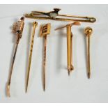 GOLD COLOURED METAL TINY DIAMOND, SAPPHIRE AND RUBY SET STICK PIN in the form of a sword and five