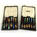 A SET OF TWELVE SILVER GILT TEASPOONS with harlequin guilloche enamelled handles, in two case,