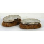 A PAIR OF MILITARY HAIR BRUSHES, with silver engine turned concave oval backs, Birmingham, 1921