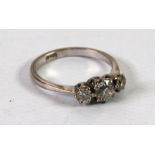 18ct WHITE GOLD RING CLAW SET WITH THREE DIAMONDS, centre stone approximately 1/2 ct;