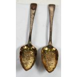 A PAIR OF GEORGE III SILVER 'BERRY' SPOONS, the Old English pattern table spoons having later