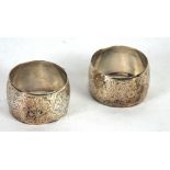 A PAIR OF VICTORIAN SILVER NAPKIN RINGS circular, floral engraved, Birmingham 1887, in original