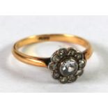 18ct GOLD AND DIAMOND DAISY CLUSTER RING, collet set, the centre diamond approximately 1/4ct