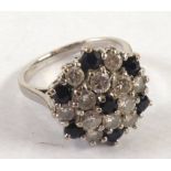 CLUSTER RING SET WITH A CENTRE SMALL SAPPHIRE and surround of six diamonds forming a daisy cluster