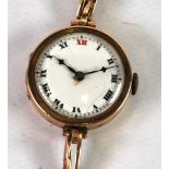 LADY'S 9CT GOLD WRIST WATCH with circular white Roman dial, 15 jewel Swiss movement and the 9ct gold