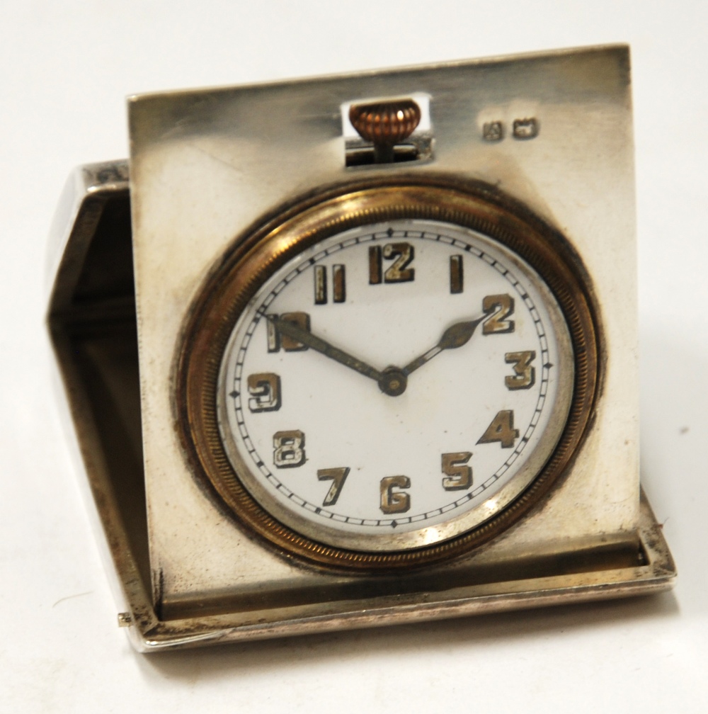 EARLY 20th CENTURY SILVER CASED ENGINE TURNED FOLDING BEDSIDE TIMEPIECE with Arabic numberals,