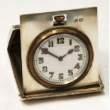 EARLY 20th CENTURY SILVER CASED ENGINE TURNED FOLDING BEDSIDE TIMEPIECE with Arabic numberals,