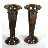 A PAIR OF SILVER PLAIN TRUMPET VASES with wavy tops, on domed circular weighted bases, 6" high,