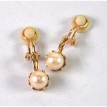 A PAIR OF 9ct GOLD CLIP EARRINGS, each with a single pearl in a cup setting, 3.5gms gross (2)