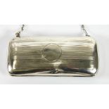 GEORGE V LADY'S ENGINE TURNED SILVER EVENING BAG, of rounded oblong form with green silk lined