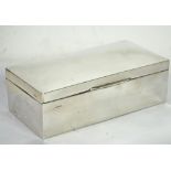 SILVER CASED TABLE CIGARETTE BOX, of typical form with domed cover, 7" x 3 1/2" (17.8cm x 8.9cm),