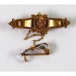 VICTORIAN 9ct GOLD WING SHAPED BROOCH, set with a tiny diamond and having glazed hair locket back