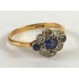18ct GOLD SAPPHIRE AND DIAMOND DAISY CLUSTER RING with centre sapphire surround of six small