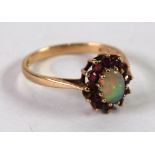 9ct GOLD, OPAL AND GARNET CLUSTER RING, set with a central oval opal and surround of 12 garnets,