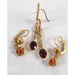 PAIR OF GOLD COLOURED METAL LONG DROP EARRINGS, spirally twisted, each with a collet set garnet