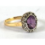 18ct GOLD, AMETHYST AND DIAMOND CLUSTER RING, set with centre oval amethyst and surround of fourteen