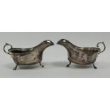 NEAR PAIR OF GEORGE V SILVER SAUCE BOATS, of typical form with flying scroll handles and stepped