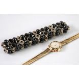 9ct GOLD AVIA LADY'S BRACELET WRISTWATCH, 15 gms gross and a white metal, black enamel and bead