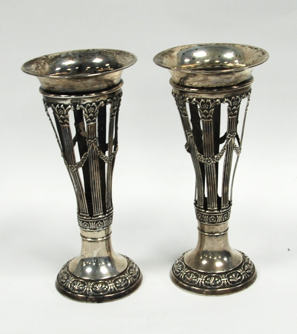 PAIR OF EDWARD VII EMBOSSED SILVER TRUMPET VASES, by Walker and Hall, each with flared rims above