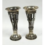 PAIR OF EDWARD VII EMBOSSED SILVER TRUMPET VASES, by Walker and Hall, each with flared rims above