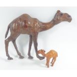 MID-EASTERN OR NORTH AFRICAN CAMEL HIDE COVERED MODEL OF A CAMEL, 11" (28cm) high and a MUCH SMALLER