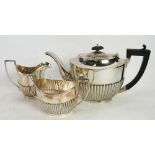 THREE PIECE ELECTROPLATED TEA SET, of oval part fluted form with angular scroll handles (3)