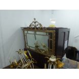 AN OBLONG WALL MIRROR IN GILT FRAME WITH ORNATE URN AND FOLIATE SCROLL PEDIMENT