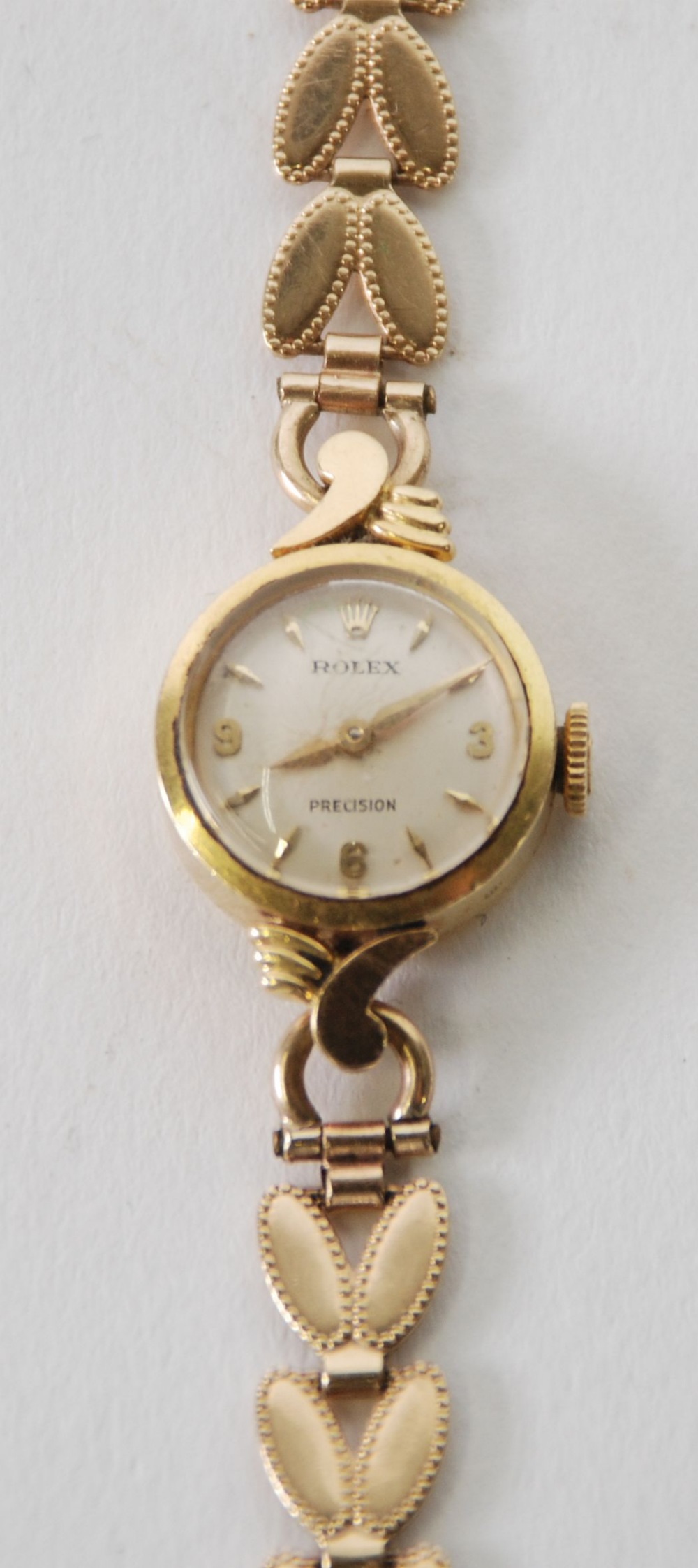 LADY'S ROLEX 'PRECISION' 18ct GOLD WRIST WATCH, with small circular silvered dial, mechanical