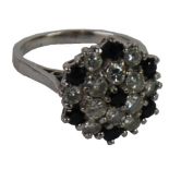 CLUSTER RING SET WITH A CENTRE SMALL SAPPHIRE and surround of six diamonds forming a daisy cluster