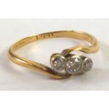 18ct GOLD CROSS-OVER RING collet set with three diamonds, approximately .17ct in total, 1.5 gms