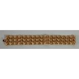 MOROCCAN GOLD COLOURED METAL BROAD BRACELET, with three rows of embossed diaper pattern links, 1"